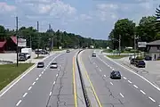 An urban expressway segment of King's Highway 11 in Severn, Ontario. Note the driveway access immediately preceding the exit ramp.