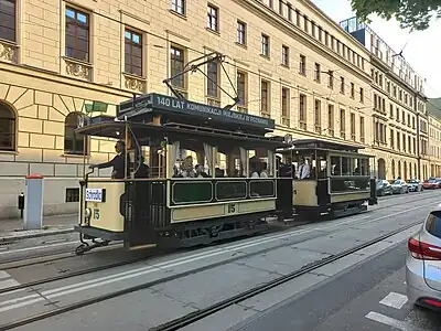 A historical tramcar through public streets in Poznań.