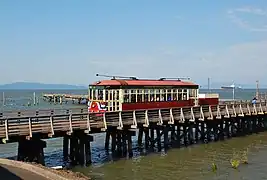 Astoria Riverfront Trolley car 300 westbound on a trestle over a minor inlet of the Columbia River.