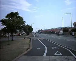 a white band of tactile paving before of a segregated cycle/foot path