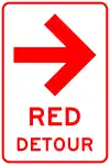 A rectangular sign with arrow and text that reads Red Detour in red. The background is white.