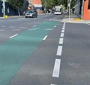 A bicycle lane in Melbourne with a green surface across an intersection