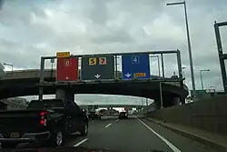 An airport wayfinding system in the United States: destination:lanes=Terminal 8|Terminal 5;Terminal 7|Terminal 4 destination:colour:lanes=red|yellow;orange|blue[1]