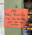 Informal sign prohibiting strollers put up by a business.