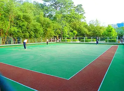 People playing gateball or a variant in Haikou People's Park, Haikou City, Hainan Province, China