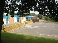 A schoolyard with a walking track and hopscotch