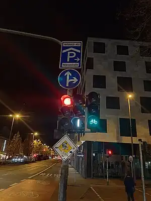 A set of three different traffic signals, one regular for general traffic (red, yellow, green), one for buses (in the states A 1, F 1 and F 0) and one for bicycles (also red, yellow, green)
