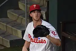 Aaron Nola sitting, glove extended.