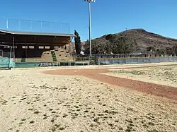 View of the concrete grandstand and home plate in the field of the Warren Ballpark.