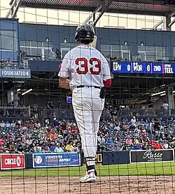 Bobby Dalbec, from behind, wearing a batting helment and walking on a field with the Worcester Red Sox in 2024