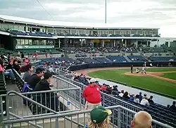 Seating bowl behind home plate as seen from the first base side