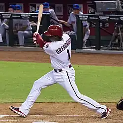 Didi Gregorius following through on a swing in a white Arizona Diamondbacks jersey