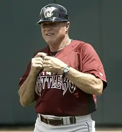 Dusty Rhodes in a red Timber Rattlers jersey and black batting helmet, holding his hands together in front of his chest