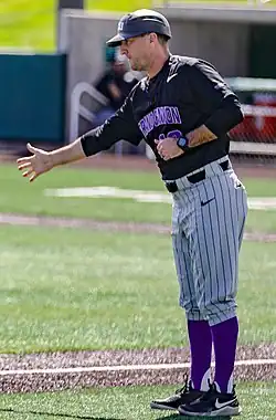 Wallis, in a Grand Canyon University uniform, holding out his right hand, likely to a not-pictured player