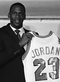 Jordan holding his Chicago Bulls jersey at conference announcing his signing