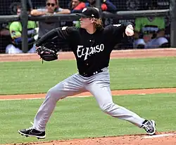Ryan Weathers in the middle of his pitching motion, wearing a black El Paso uniform