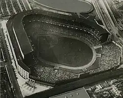 Black and white aerial view of Old Yankee Stadium, looking towards home plate from the outfield.