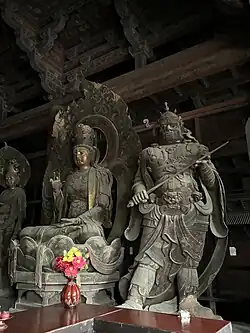 Liao dynasty (916-1125) statue of Guanyin flanked on the left by a Heavenly King at Huayan Temple in Datong, Shanxi, China.