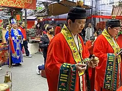 Taoist priests of Taiwan wearing ceremonial garments consisting of traditional fayi and cross-collared inner robes, Tucheng District, New Taipei City.