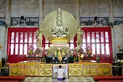 Statue of Qianshou Qianyan Guanyin flanked by the dharmapalas Weituo and Qielan at Kong Meng San Phor Kark See Monastery in Singapore.
