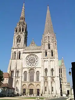 The Flamboyant Gothic north tower (finished 1513) (left) and older south tower (1144–1150) (right)