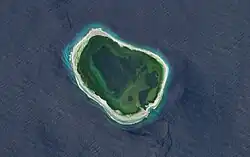 A small ring island surrounded by the ocean