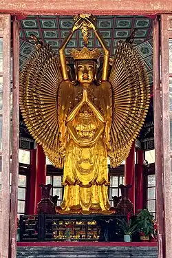 Qing dynasty (1644-1912) statue of Qianshou Qianyan Guanyin at Daxiangguo Temple, Kaifeng, Henan, China. Carved during the reign of the Qianlong Emperor (1735-1796), the statue consists of four front profiles of Guanyin, facing each of the four directions.