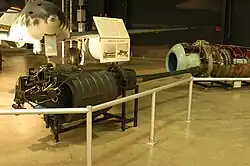 German BK 5 50&nbsp;mm aircraft autocannon displayed in front of the Me 262A jet, a design once tested with it