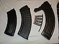 Magazines for three different 7.62×39&nbsp;mm rifles and a stripper clip loaded with ammunition