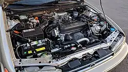 Internal combustion engine that says "programmed fuel injection" and "16-valve Honda" on the top.