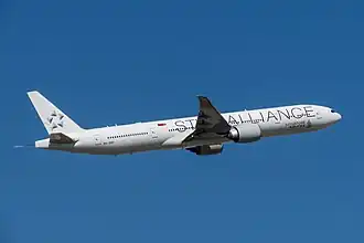 A Singapore Airlines Boeing 777-300ER in its recent Star Alliance livery: note the white tail with the Star Alliance logo.