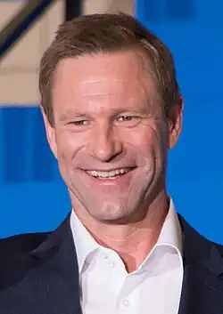 A photograph of Aaron Eckhart