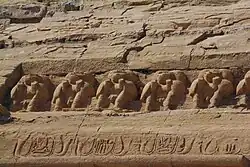 The carvings of baboons on the cornice above the heads of the statues of Ramesses II at the Great Temple