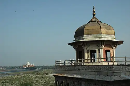 A distant view of the Taj Mahal from the Agra Fort, both built by Mughal emperor Shah Jahan in the late 17th century