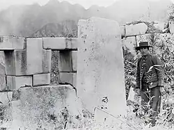 Interior of Machu Picchu's Temple of the Three Windows, with a person standing on the right.