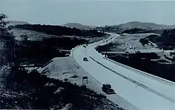 Black-and-white photo, with few cars