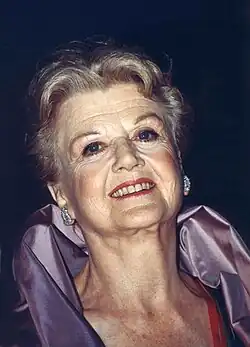 An older white woman looking towards the viewer.