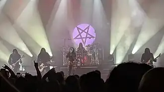 Arch Enemy in 2025; from left to right: Michael Amott, Sharlee D'Angelo, Alissa White-Gluz, Daniel Erlandsson (on drums) and Joey Concepcion