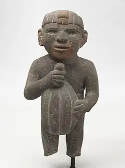 Sculpture of a man carrying a cacao pod. Aztec, 1440-1521 AD