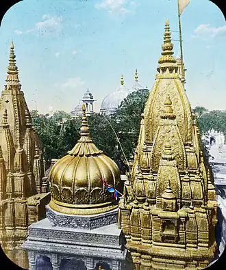 The Kashi Vishwanath Temple was destroyed by the army of Qutb ud-Din Aibak in 1194 CE. Since then, it has been demolished twice (in the 1400s, and 1669 CE) and rebuilt four times (in the 1200s and twice in the 1500s). The current structure was built by Ahilyabai Holkar on an adjacent site after the demolition by Aurangzeb. Shown is the current temple, with a gold temple roof, donated by Ranjit Singh in 1835.[139][140]