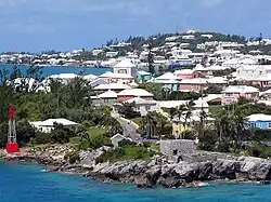 Residential suburb near the old St.&nbsp;George's Garrison, with "Town Cut Battery" or "Gate's Fort" on the shore of the Town Cut, and St.&nbsp;George's Town and its harbour in the background