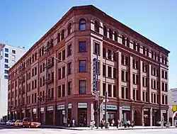 A photograph of a building interior showing stairs climbing up five storeys to the final floor where we can see the glass roof.