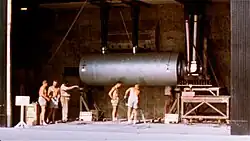 Shot-cab installation of SHRIMP device, with humans for scale