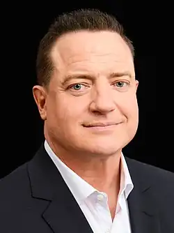 Fraser looking to the camera, wearing a suit