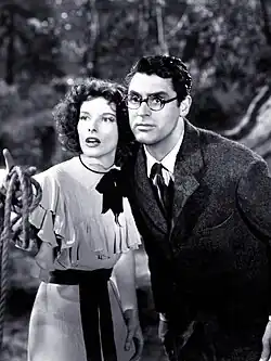 Hepburn and Cary Grant in Bringing Up Baby, she is pointing at something and both look alarmed.