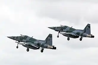 Two F-5M taking off in aerial alert