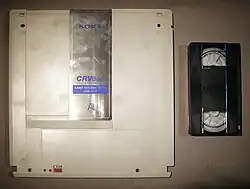 A CRVdisc with a VHS tape for size comparison