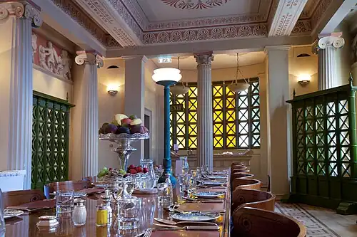 New Classical Greek Revival Corinthian column in the Gonville and Caius College Hall, Cambridge, UK, inspired by the one from the Temple of Apollo at Bassaem by John Simpson, 1998