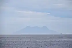 Silhouette of Mt. Timpoong (L) and Mt. Mambajao (R), the highest peaks of the largest mountain in Camiguin, as seen from the north, across Bohol Sea