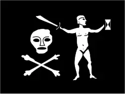 Flag of Jean Thomas Dulaien, described as “The flag was black, with a skull and crossbones below on the hoist and a naked man holding a cutlass in one hand and over the skull and bones and an hourglass in the other, on the fly.” There is no evidence of Walter Kennedy flying this flag; after he mutinied against Bartholomew Roberts, Kennedy and the rest of the crew retired from piracy and sailed to Ireland.[48]